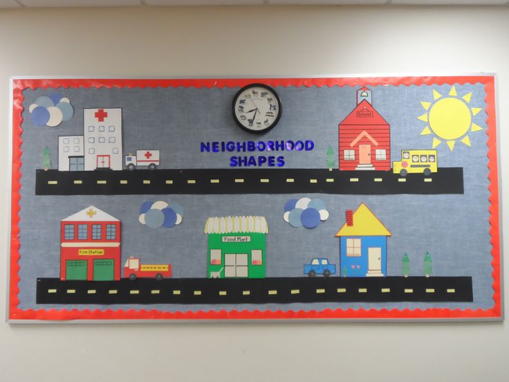 a bulletin board that says neighborhood shapes with a clock on the top and houses in the middle