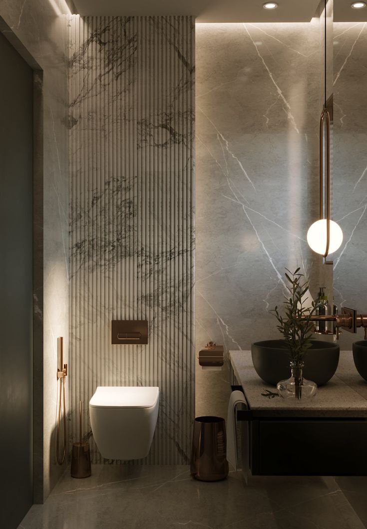 a bathroom with marble walls and flooring next to a white toilet in the corner