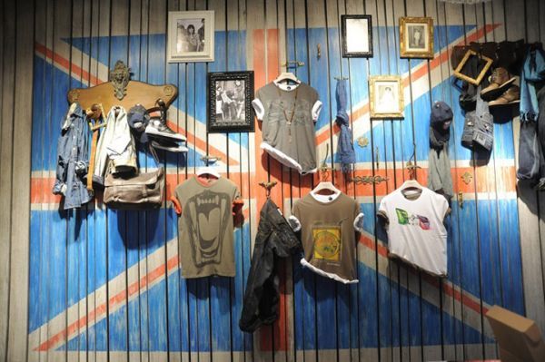 an union jack flag is hanging on the wall next to clothes and other clothing items