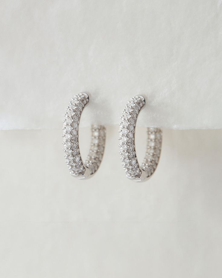 Our Real Diamond Amalfi Huggies are pave version of our Real Deal Amalfi Huggies- featuring glistening white diamonds on both the outer and inner curves of each hoop. The diamonds sparkle in every angle, elevating any outfit and perfect for all day wear. White Diamond Sparkling Hoop Earrings, Sparkling White Diamond Hoop Earrings, Dazzling White Sparkling Hoop Earrings, White Cubic Zirconia Sparkling Hoop Earrings, White Sparkling Cubic Zirconia Hoop Earrings, Sparkling White Cubic Zirconia Hoop Earrings, Luxury Pave Set Hoop Earrings For Wedding, Luxury Hoop Earrings With Pave Setting For Wedding, Luxury Wedding Hoop Earrings With Pave Setting