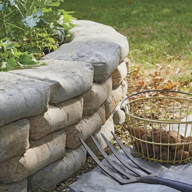 a fork and basket sitting next to a stone wall