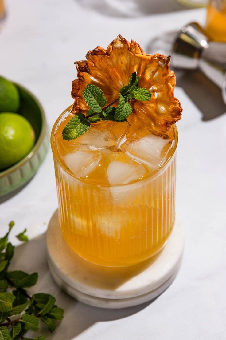 a glass filled with lemonade and mint on top of a table