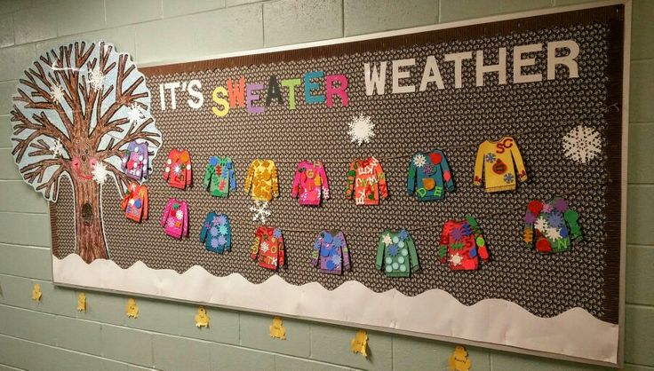 a bulletin board with clothes hanging from it's sides and a tree in the middle