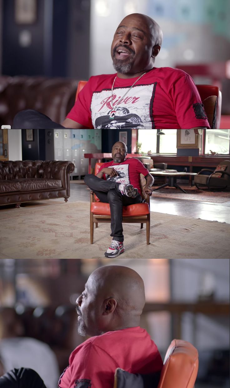 a man sitting on top of a chair next to another man in a red shirt