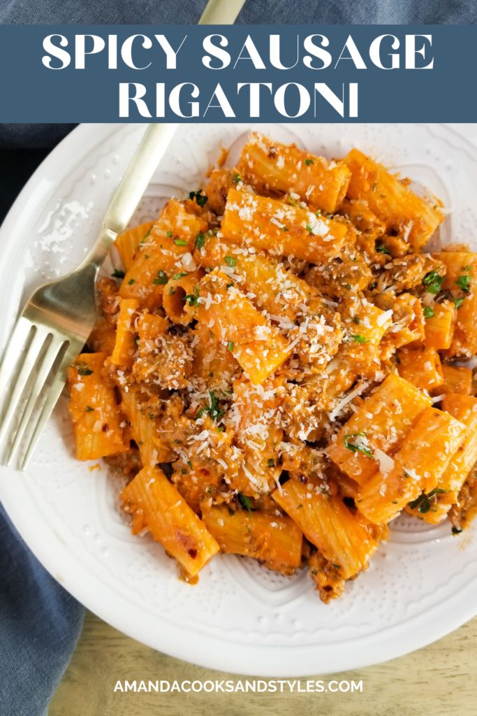 a white plate topped with pasta and parmesan cheese