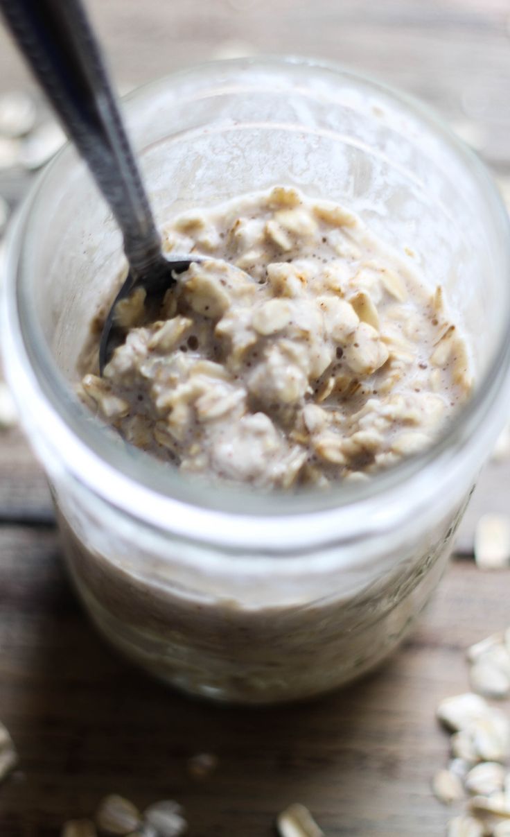 a jar filled with oatmeal sitting on top of a wooden table