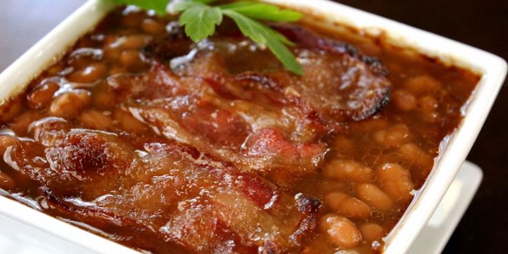 a white plate topped with beans and meat