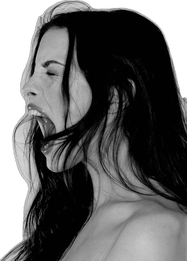 a woman with her mouth open and long hair blowing in the wind while wearing a bra