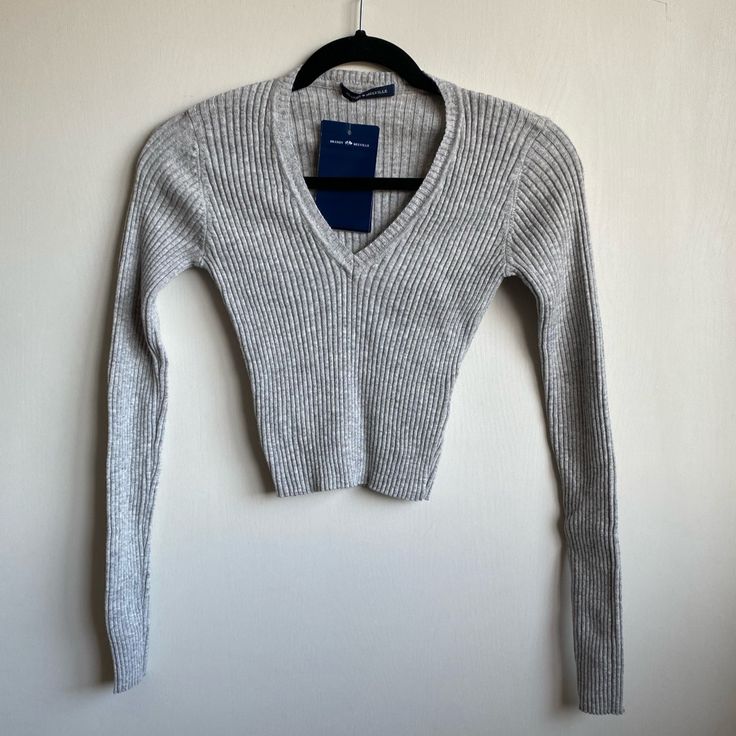 Light Heather Grey Long Brandy Melville V-Neck Sweater Made From Wool. It’s Nwt So In Perfect Condition I Didn’t Love It As Much As I’d Hoped I Would So I’m Selling It, It’s Still Super Cute Though. Fitted Ribbed V-neck Sweater, Fitted V-neck Top For Fall, Brandy Melville Sweaters, Tokio Hotel, Brandy Melville, Sweater Making, Grey Long Sleeve, Cropped Sweater, Teen Fashion Outfits