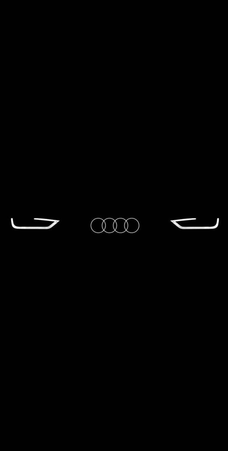 an audi logo is shown in the dark with white lines on it's face