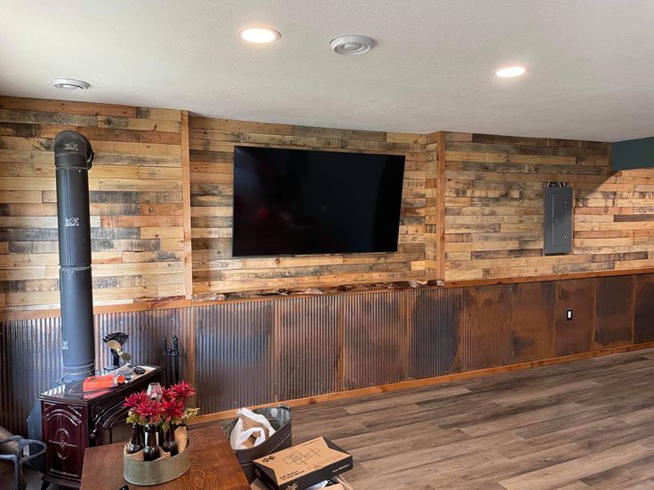 a living room with wood paneling and a flat screen tv mounted on the wall