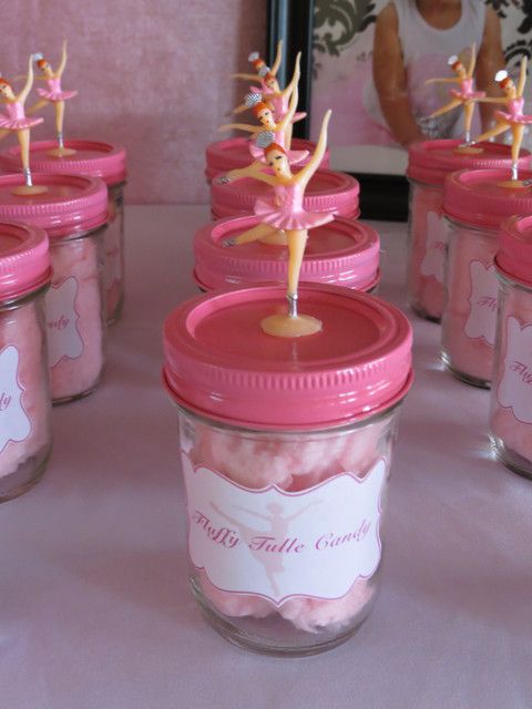 there are many pink jars with little figurines in them