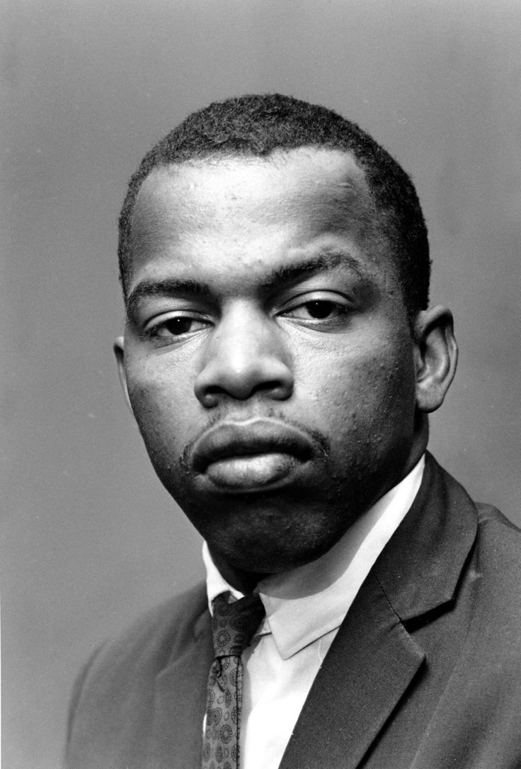 a black and white photo of a man in a suit with a serious look on his face