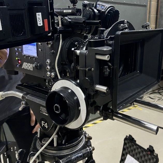 a camera being used on a tripod in a room with other equipment around it