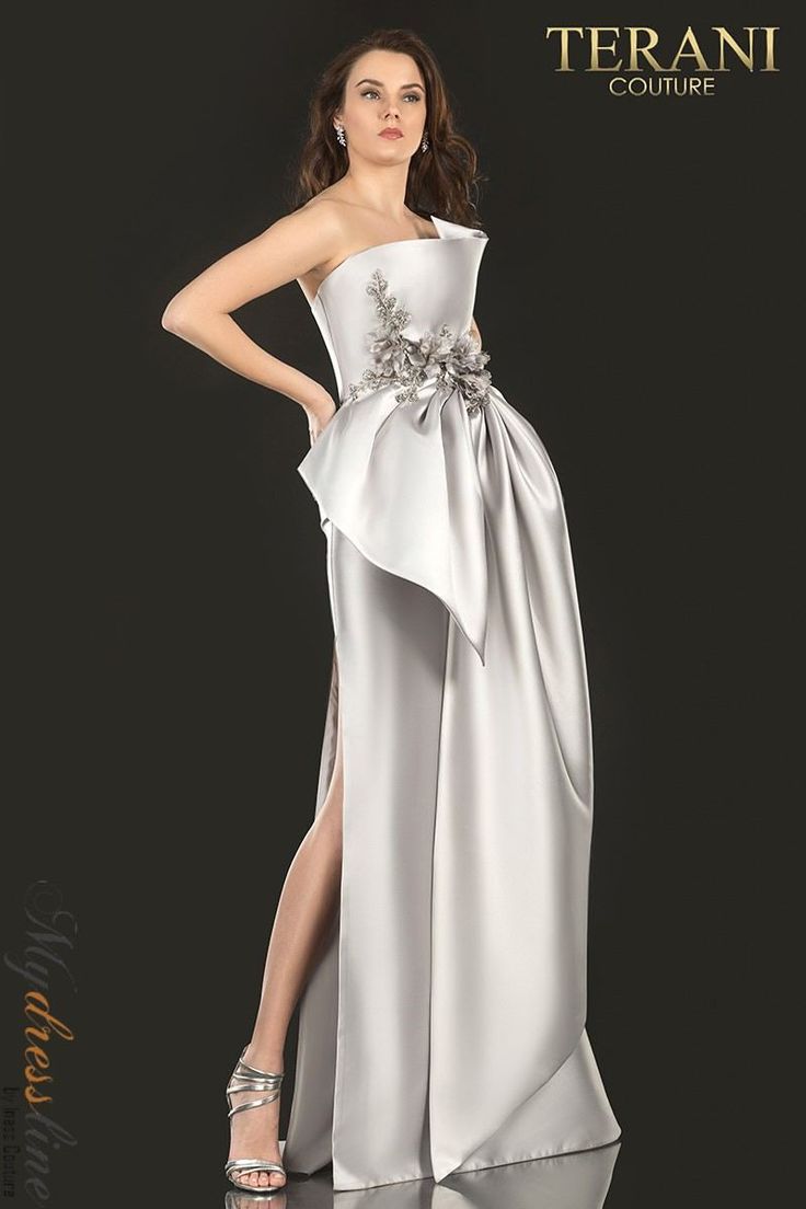 Looking for a stand-out dress for your next formal event? Look no further than the Terani Couture 2021E2876! This stunning gown features a three-dimensional sculptured bodice with cascading flowers and beads, along with an oversized draped bow skirt. You're sure to turn heads when you walk into the room wearing this show-stopping dress! Terani Dresses, Colorful Dresses Formal, Formal Dresses With Sleeves, Plus Size Cocktail Dresses, Plus Size Party Dresses, Terani Couture, Burgundy Bridesmaid Dresses, Long Evening Gowns, Black Bridesmaid Dresses