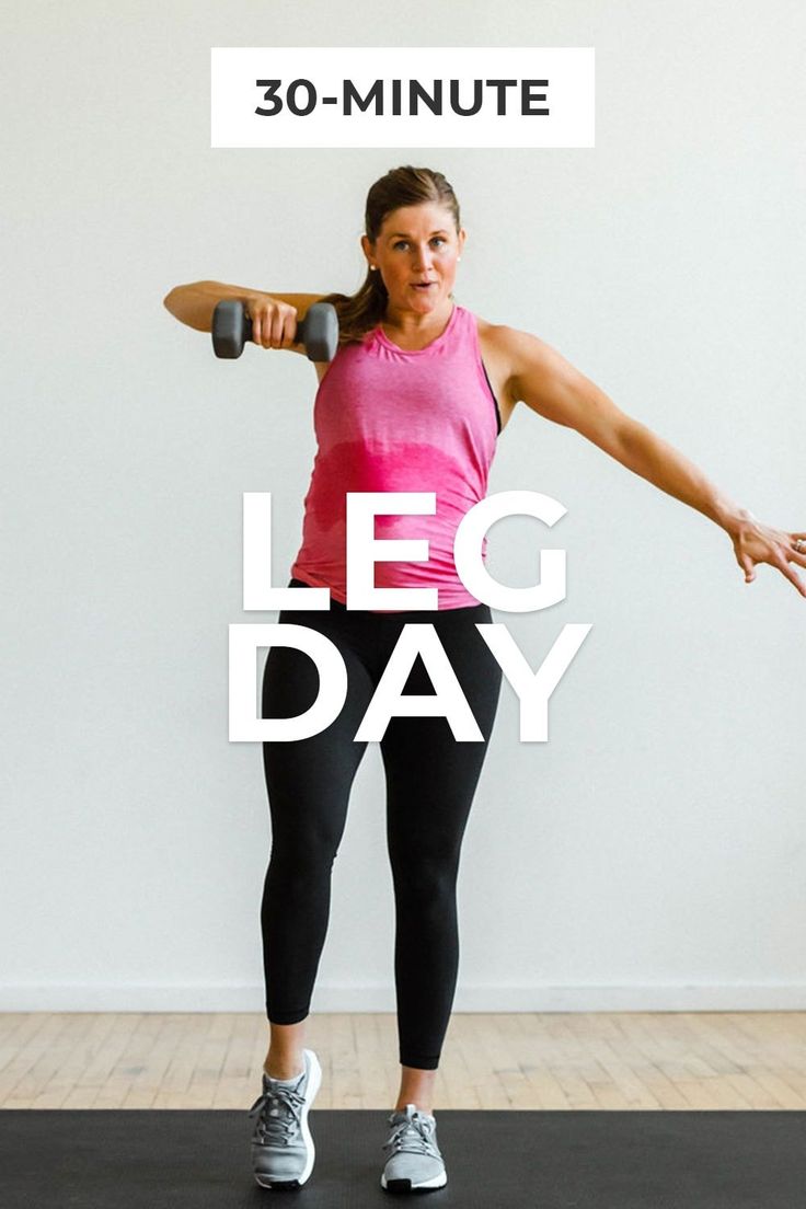 a woman in pink shirt and black leggings doing exercises with dumbbell bar