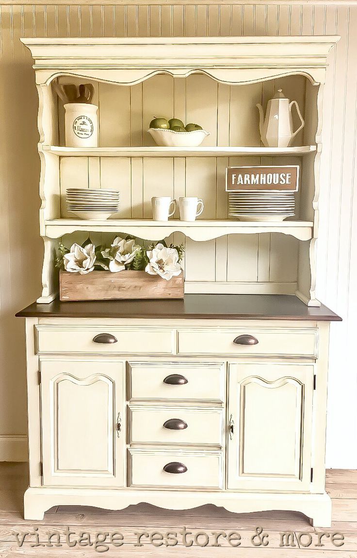 an old china cabinet is painted white