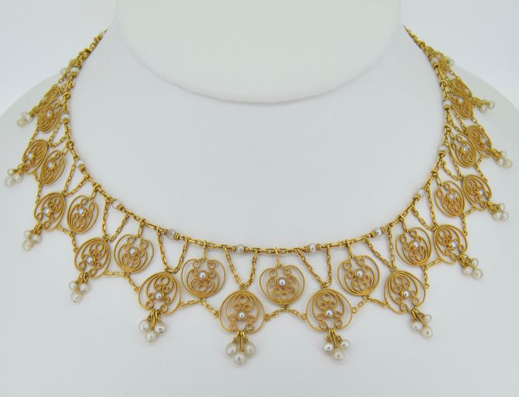 OHHHHH this necklace is so very special. I believe it to be of French origin (however not hallmarked), dating from the 1870s+/-. This necklace is presented in excellent condition. It is crafted from 18K solid yellow gold. The necklace is a full collar necklace, going around the entire neck. It features two tiers all connected to one another with chains to allow for a fabulous natural lay on the neck. The chains are oblong oval gold links. The top is adorned with drilled seed pearls (roughly 2 mm Baroque Necklace With Historical Design As A Gift, Baroque Historical Design Necklace For Gift, Elegant Baroque Necklace With Historical Design, Victorian Necklace With Historical Design As Gift, Seed Pearl Necklace, Baroque Necklaces With Historical Design For Wedding, Baroque Necklace With Historical Design For Weddings, Heirloom Pendant Necklace With Intricate Design, Elegant Yellow Gold Jewelry With Historical Design