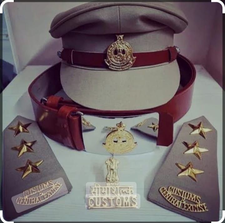 a hat, belt and badges are on display