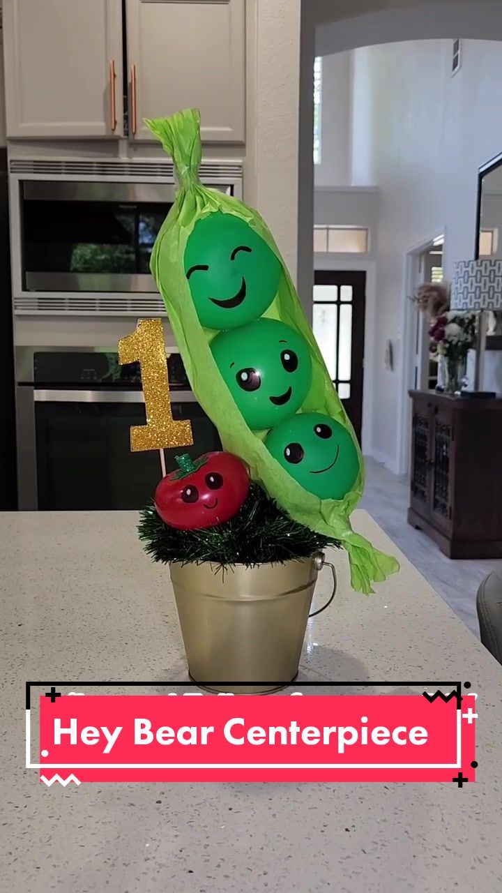 there is a potted plant with three peas in it and the number one on top