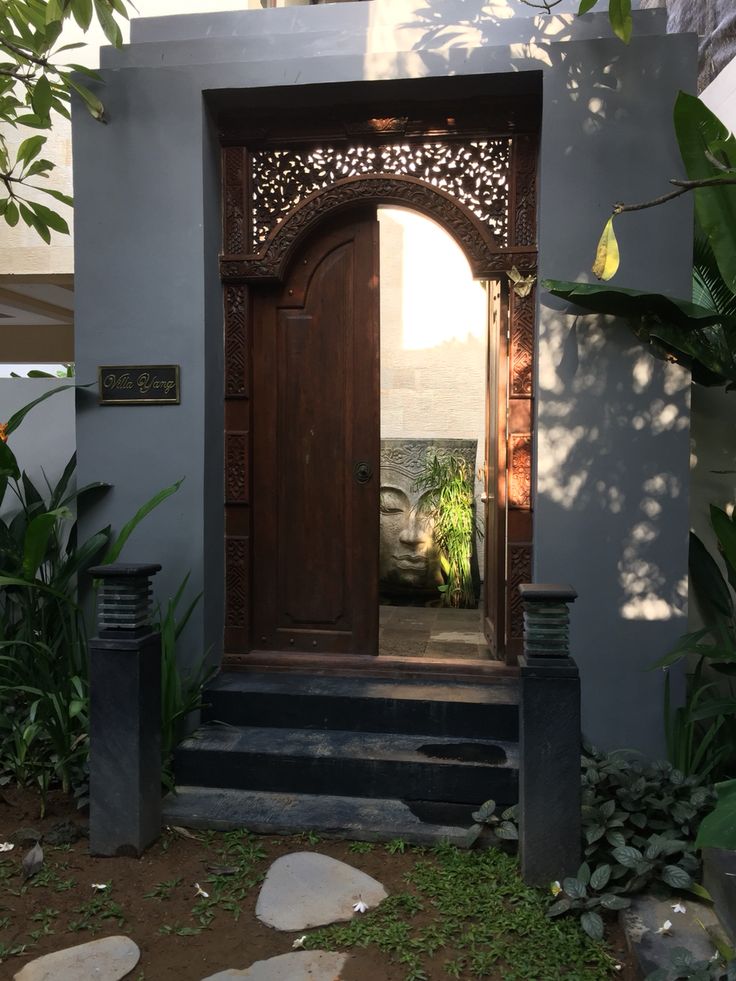 an entrance to a house with a wooden door