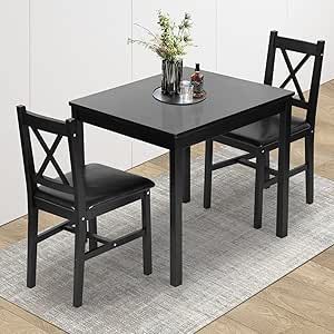 a black table and two chairs on a rug