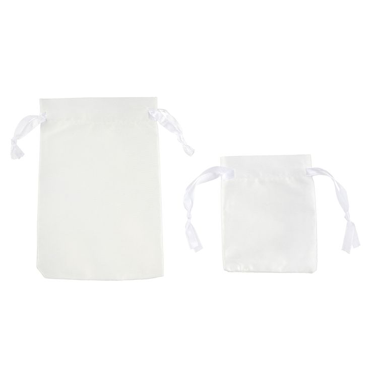 two white bags with ties on them sitting next to each other