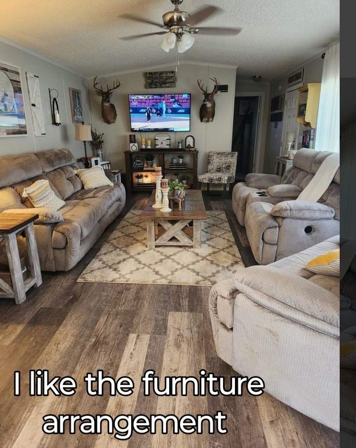 a living room with two couches and a coffee table in front of a tv