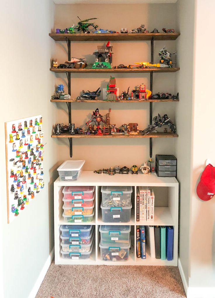 a room with shelves filled with toys and legos on top of each shelf in front of the wall