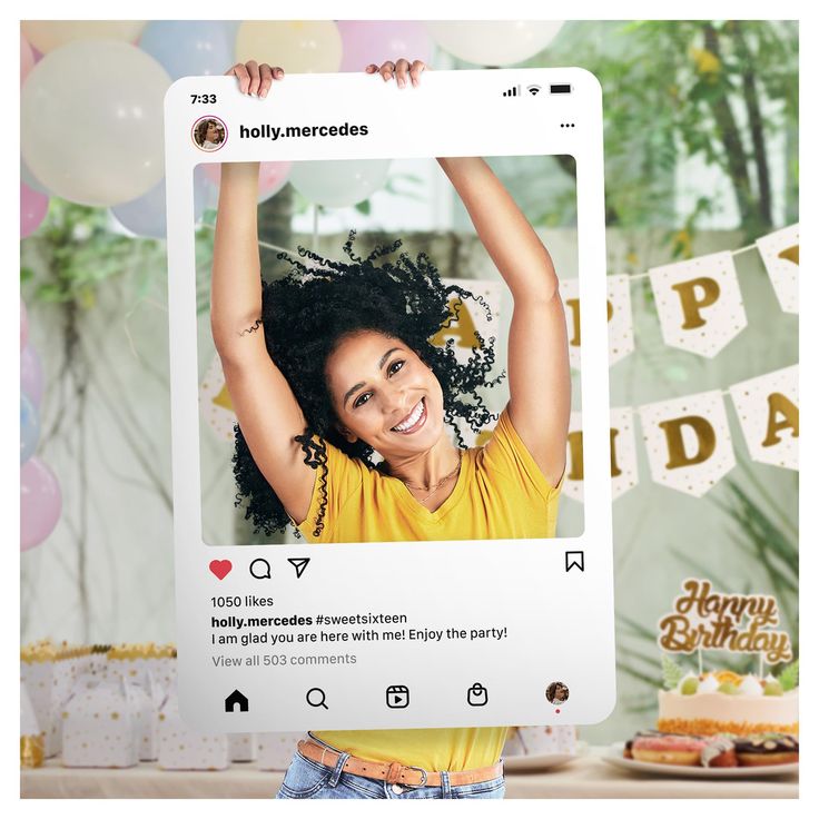 a woman holding up a birthday card with an image of her on it and balloons in the background