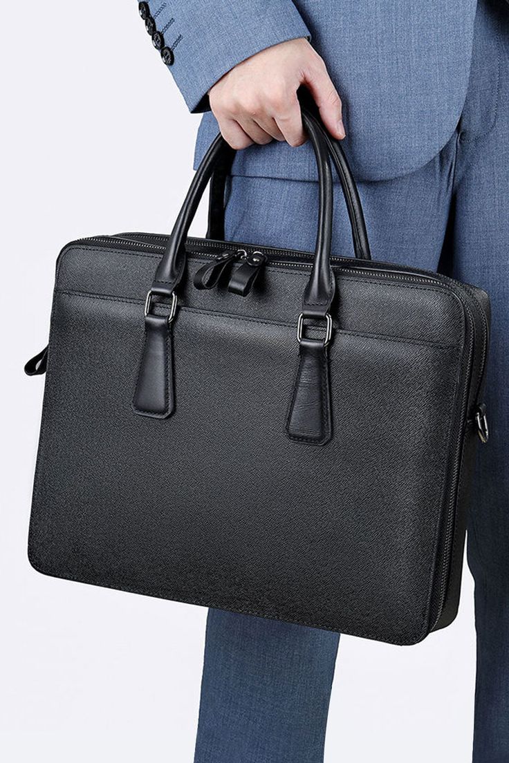 Introducing the Genmarks Deluxe Office Bag - the epitome of sophistication and practicality. Made with premium full-grain real leather, this office bag is built to last and exude a sense of elegance. The sleek and professional design of the bag makes it perfect for carrying all your work essentials, whether you're heading to the office or a business meeting. The spacious interior and multiple compartments allow you to keep your documents, laptop, and other essentials organized and easily accessi High-end Business Bags With Top Carry Handle, High-end Top Handle Business Bag, High-end Top Handle Bag For Business, High-end Business Bags, Business Satchel With Double Handle And Textured Leather, Office Briefcase With Textured Leather And Top Handle, Textured Leather Top Handle Briefcase For Office, Saffiano Leather Briefcase With Top Handle For Business, Saffiano Leather Briefcase With Top Handle For Office