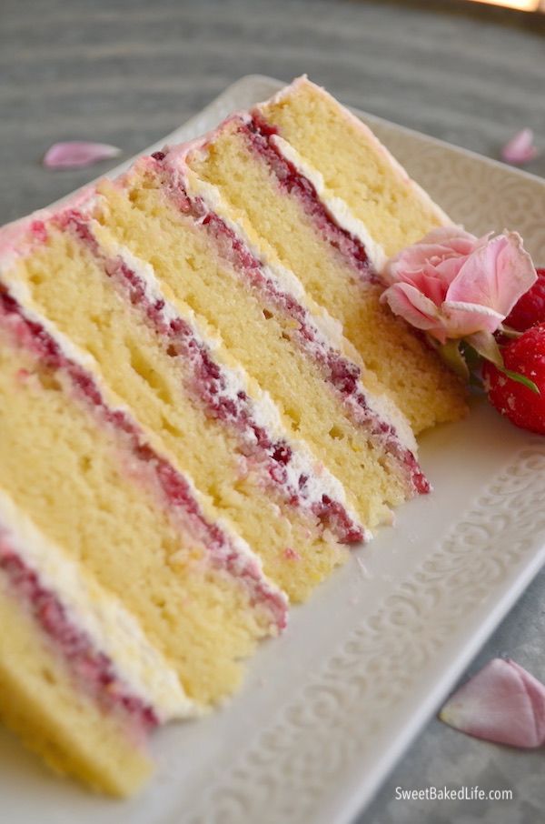 there is a piece of cake and a strawberry on the plate next to each other