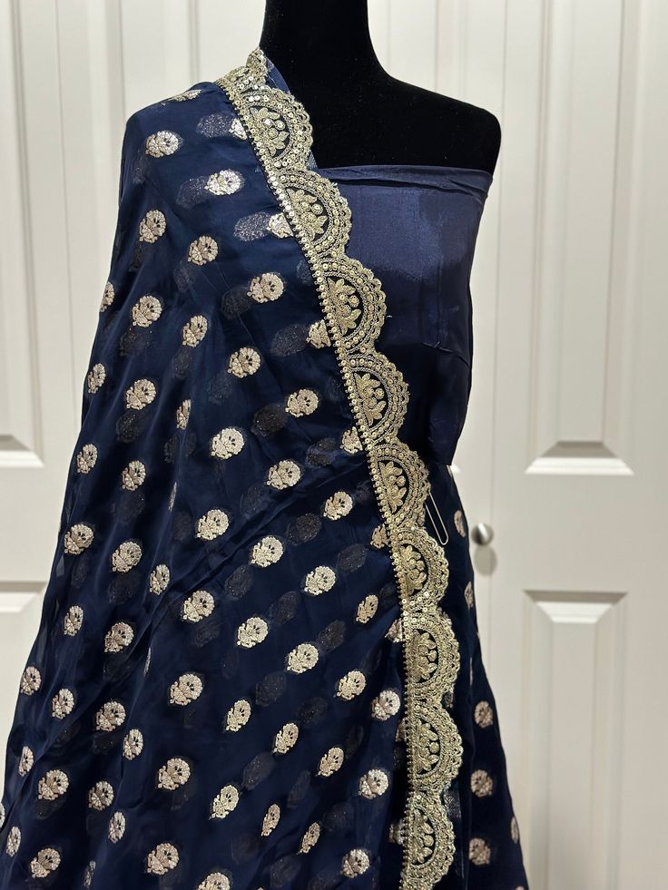 Such a gorgeous Banarsi Georgette saree with designer gotta Patti weaving is shindig ready , refreshing and unique . Get closer and look at the detailing of this impeccable work . Luxury , beauty and style comes alive altogether in this beautiful piece. This saree is ready to wear with fall, pico and unstitched blouse fabric is included. color- midnight blue / gold zari Note: Colors that show up on your screen may vary slightly from the actual product due to variations in settings. Also, the act Blue Bollywood Anarkali Set With Gota Work, Diwali Dola Silk Salwar Kameez With Gota Work, Blue Chanderi Traditional Wear With Gota Work, Fitted Chanderi Saree With Gota Work, Anarkali Silk Saree With Gota Work, Fitted Gota Work Pre-draped Saree In Chanderi, Fitted Chanderi Pre-draped Saree With Gota Work, Traditional Drape Salwar Kameez With Gota Work For Diwali, Fitted Pre-draped Gota Work Saree In Chanderi