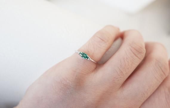 Solid 14k gold Emerald ring / Dainty marquise emerald ring / Stackable marquise emerald ring / Dainty emerald ring / Stacking marquise emerald ring Essential Material Details:   ∞ Made to Order∞ Metals: Available in both solid gold and 925 sterling silver (please see below)∞ Gold Kt: 9K, 10K, 14K, 18K ∞ Available Gold Color: Rose Gold, Yellow Gold, and White Gold∞ Silver: Solid 925 Sterling Silver∞ Available 925 Sterling Silver Plated Color: Rose Gold, Gold and Silver∞ Setting: 100% Authentic Na Green Crystal Ring For May Birthstone, Dainty Green Birthstone Open Ring, Green Dainty Crystal Ring With Birthstone, Dainty Green Birthstone Promise Ring, Dainty Green Jewelry With Simple Design, Minimalist Green Crystal Promise Ring, Green Sterling Silver Minimalist Ring, Dainty Green Round Midi Rings, Dainty Green Midi Promise Ring