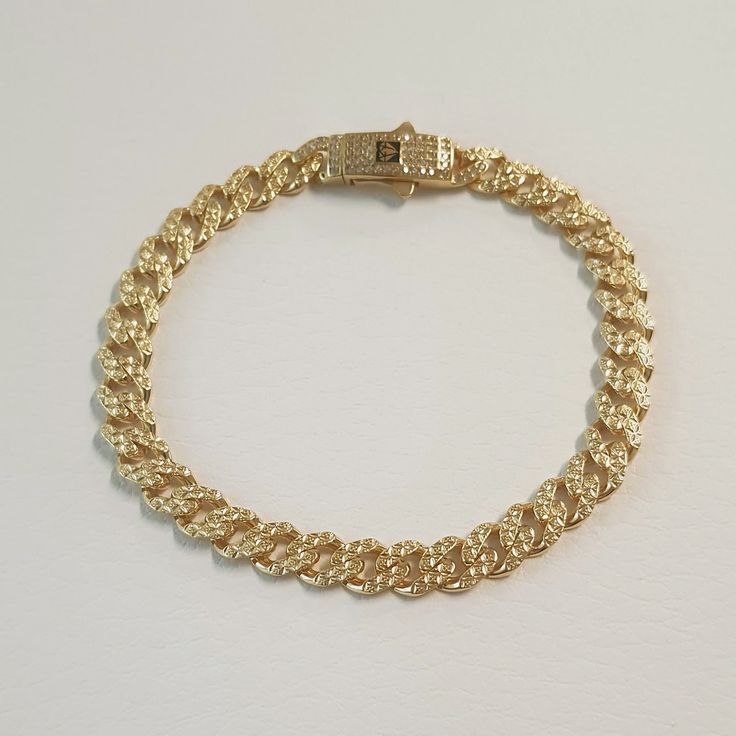 Step into sophistication with our exquisite Miami cuban chain bracelet, a timeless piece handcrafted from luxurious 14K solid gold. Welcome to Allegro Fine Jewelry, where elegance meets craftsmanship, and each detail is meticulously designed to perfection. Indulge in luxury with our Curb anklet or bracelet featuring a delicate 7 mm cuban link chain adorned with a dazzling CZ station in a secure prong setting. This elegant accessory is more than just jewelry; it's a symbol of love and commitment, perfect for wedding gifts or any special occasion. CZ station with prong setting for added glamour. Also, it is ideal gift for weddings, anniversaries, or any celebration of love. 🌸 Elevates her style with timeless elegance 🌸 Makes a meaningful and cherished wedding gift 🌸 Handcrafted with love Elegant Gold-plated Cuban Link Bracelet, Luxury Tarnish-resistant Gold Cuban Link Bracelet, Elegant Gold-tone Cuban Link Bracelet, Gold Cuban Link Bracelet, Gold-tone Cuban Link Bracelet For Gift, Everyday Yellow Gold Cuban Link Bracelet, Tarnish Resistant, Chain Bracelet For Women, Cuban Chain Bracelet, Jewelry For Mom