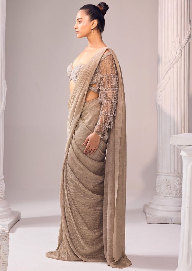 Inspired by the surreal magnificence of glits and glam this saree is sure to be a highlight. Celebrate your special occasion this season in our sartorially designed ensemble with dainty details and vibrant tassels. Festive Draped Sharara With Sheer Dupatta, Bollywood Style Pre-draped Tissue Silk Saree, Party Saree With Cutdana And Draped Style, Bollywood Style Tissue Silk Pre-draped Saree, Reception Saree With Cutdana Embroidery, Semi-stitched Draped Saree For Reception, Eid Tissue Silk Saree In Traditional Drape, Festive Draped Traditional Wear With Dupatta, Tissue Silk Pre-draped Saree For Eid