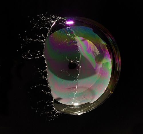 an image of a glass object in the dark with water droplets on it's surface