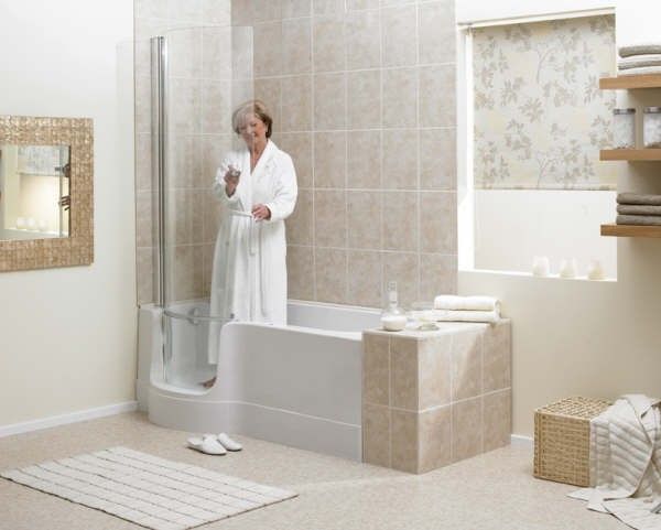 a woman in a bathrobe standing next to a tub