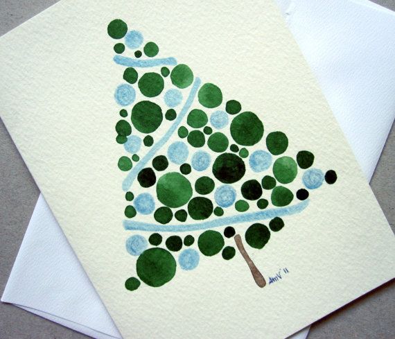 a handmade christmas card with a green tree on the front and blue dots on the back