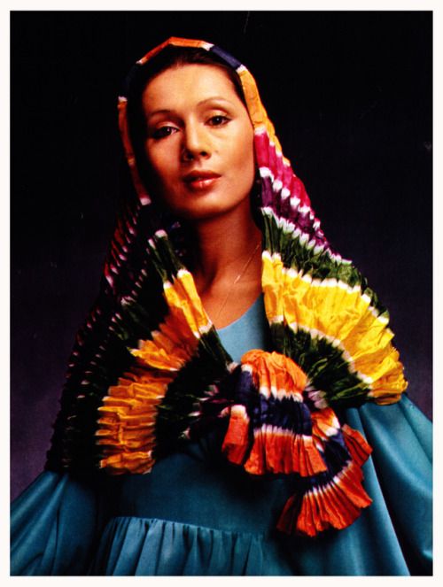 a woman wearing a colorful scarf and headdress