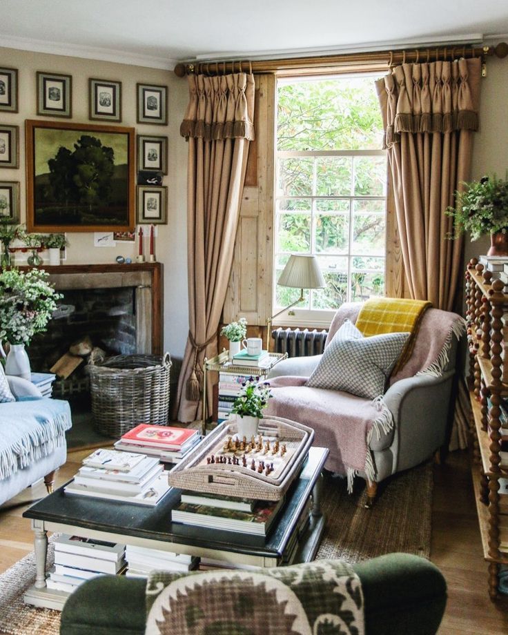 a living room filled with furniture and a fire place in front of a large window