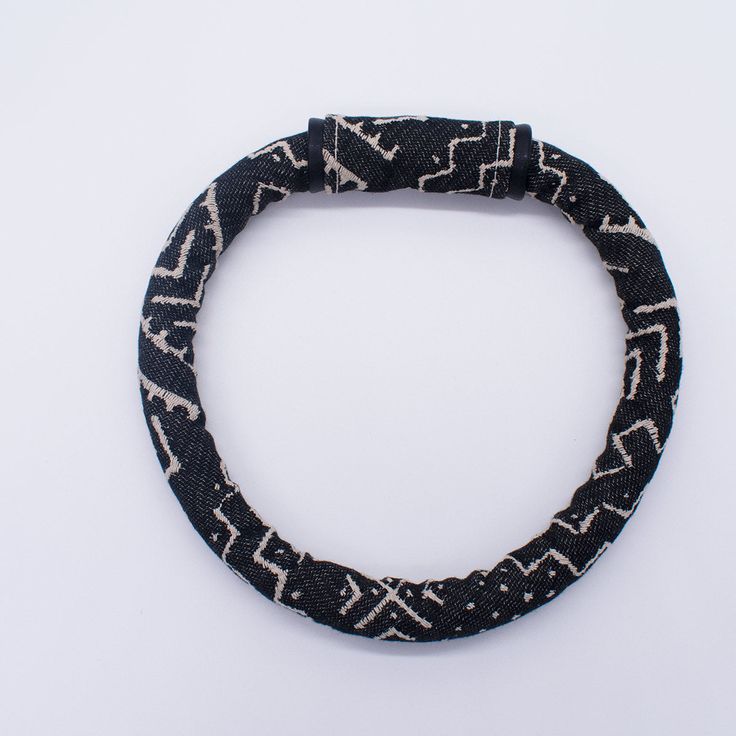 This black and cream himba necklace can be worn multiple ways: you can have the closure to the back of your neck or adjust to show in the front. The pattern shows the detail of this piece. It is definitely a great fashion statement! Measurement: Length: 27 in, Width: 1 in. Color: Black and Cream Fabric: Faux mud cloth fabric Closure: Magnetic closure *** This includes the Himba necklace only *** (Earrings sold separately) Note: Each item is handmade, due to variances in the fabric print each ite Artisan Black Beaded Necklace Handwoven, Artisan Black Handwoven Beaded Necklace, Artisan Handwoven Black Beaded Necklace, Black Fair Trade Jewelry For Festivals, Fair Trade Black Jewelry For Festival, Artisan Black Beaded Necklaces With Adjustable Fit, Artisan Black Adjustable Beaded Necklaces, Artisan Black Adjustable Beaded Necklace, Adjustable Black Artisan Beaded Necklace