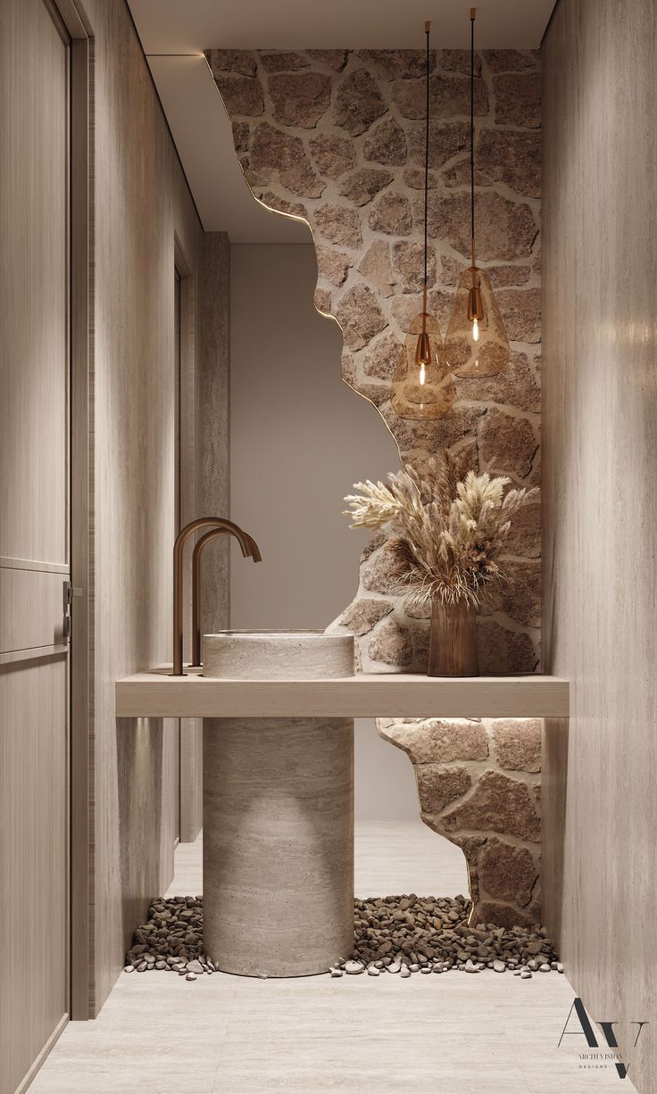 a bathroom with stone walls and flooring next to a sink under a light fixture