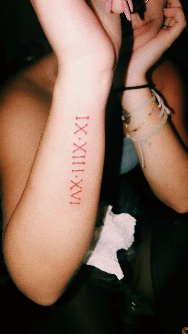 Red Tattoo Roman Numerals, Red Roman Numeral Tattoo Arm, Roman Numeral Fonts Tattoo, Roman Numeral Tattoo Red Ink, Red Roman Numeral Tattoo, Red Arm Tattoos For Women, Numeral Number Tattoo, Red Arm Tattoo, Roman Numeral Tattoo Arm