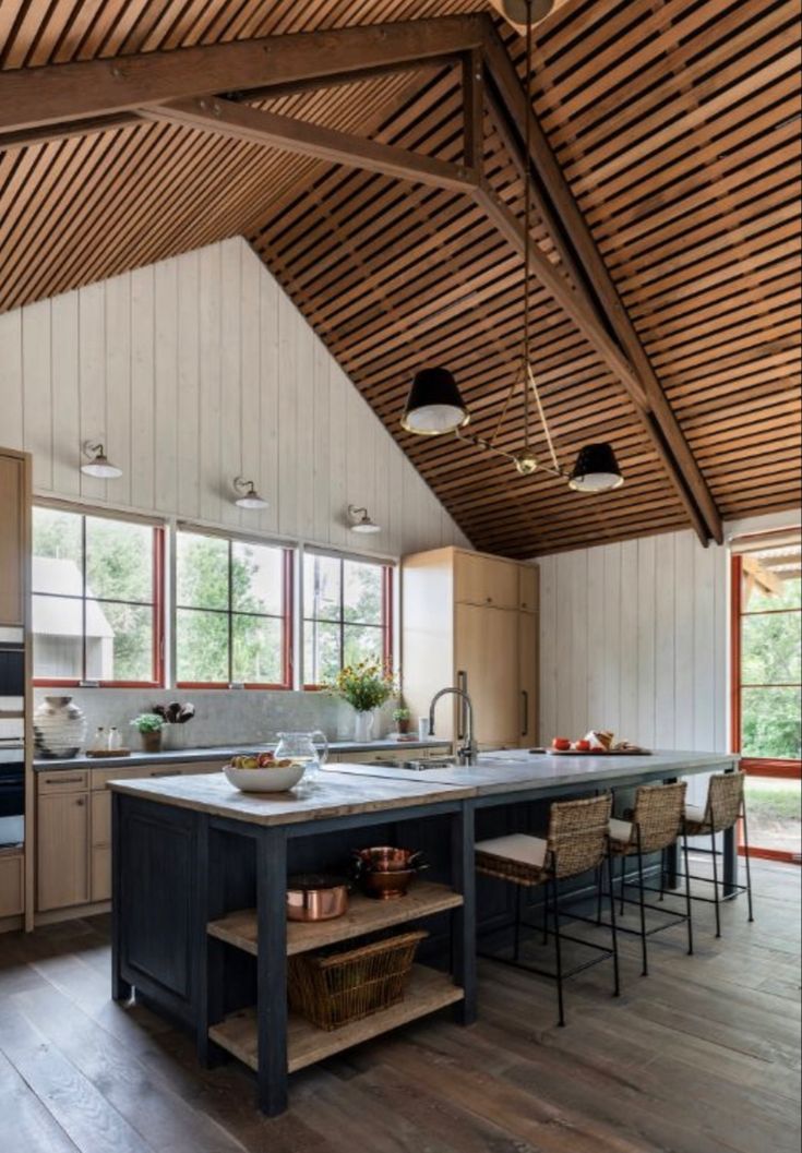 a large kitchen with an island in the middle