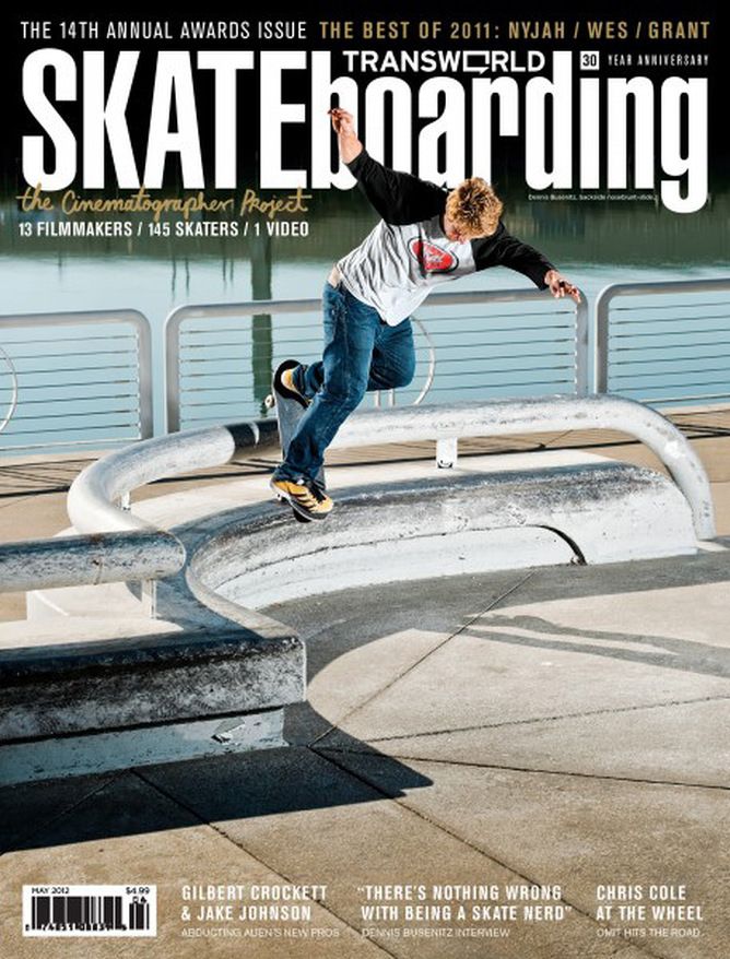 a man riding a skateboard down the side of a metal rail on top of cement