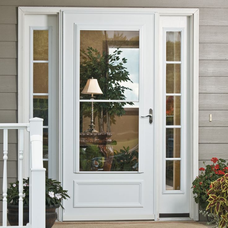 a white front door with a lamp on it