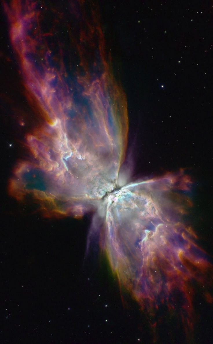 a butterfly shaped object in the sky with bright colors and stars on it's side