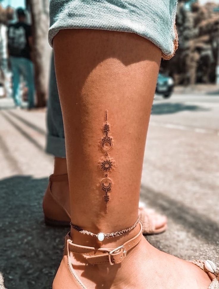 a woman's foot with a small tattoo on the side of her leg and ankle