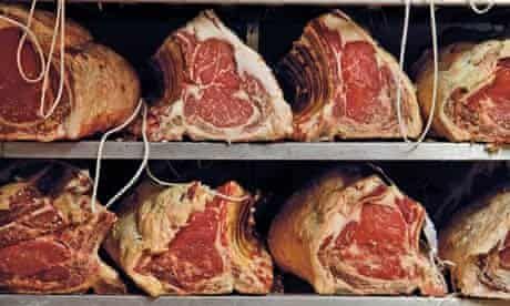 several racks of meat in a butcher shop